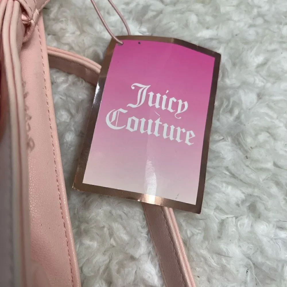 Juicy Couture pink and gold synthetic leather crossbody bag.